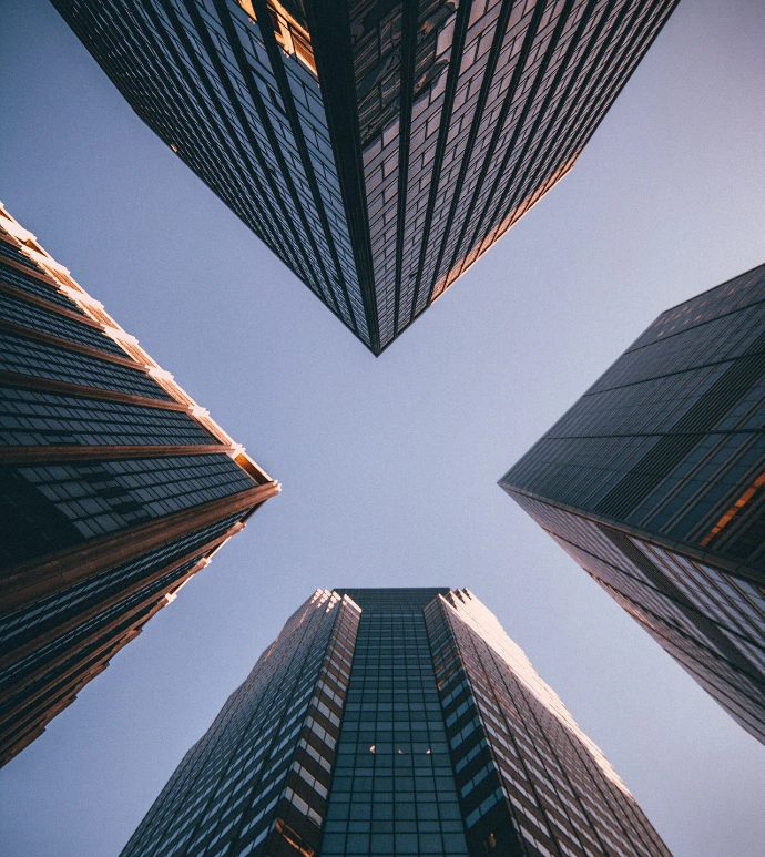 low-angle photography of four high-rise buildings